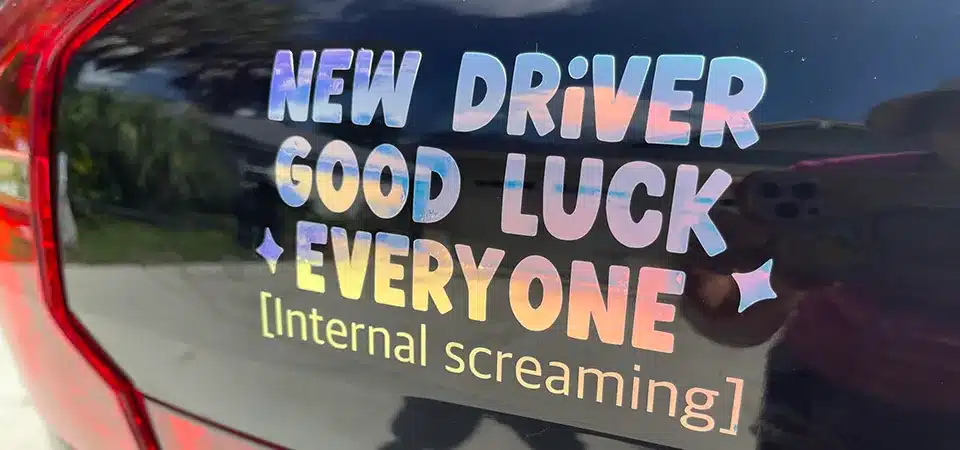 Waterproof Stickers in a Car Wash A car covered in custom stickers going through an automatic car wash, with water spraying everywhere