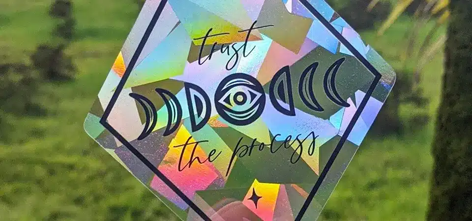 A holographic sticker for Clark Planetarium with a celestial slogan