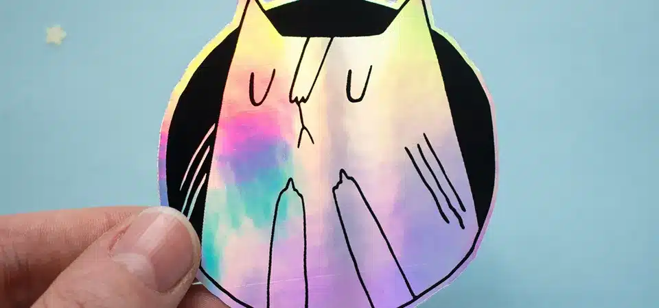 A colorful cartoon cat holographic sticker with holographic eyes