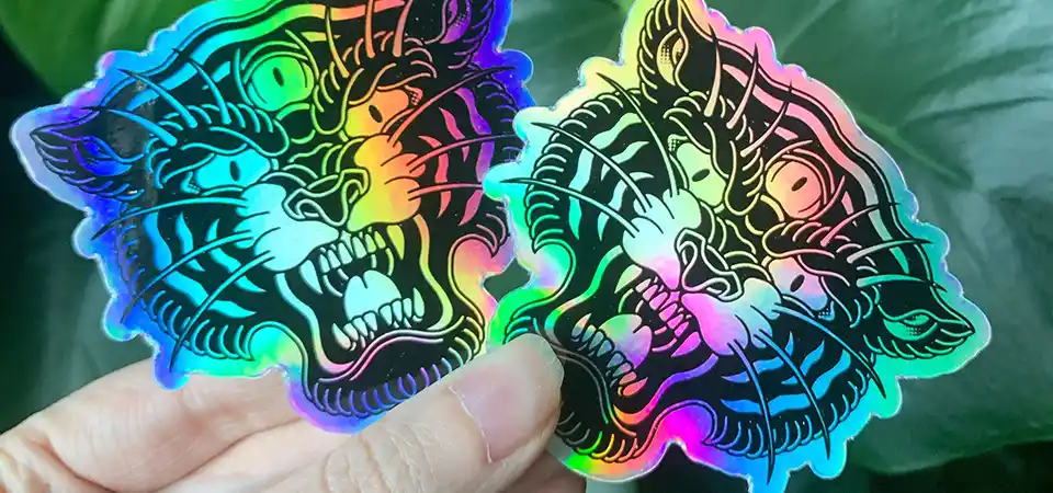 A holographic sticker of a crouching tiger with holographic stripes
