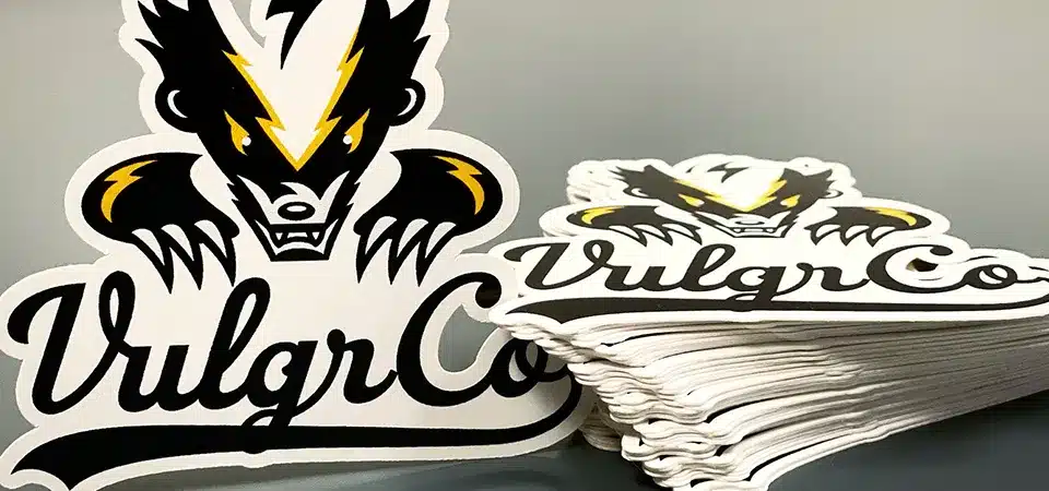 A vibrant display of stickers with different finishes like holographic, matte, and gloss