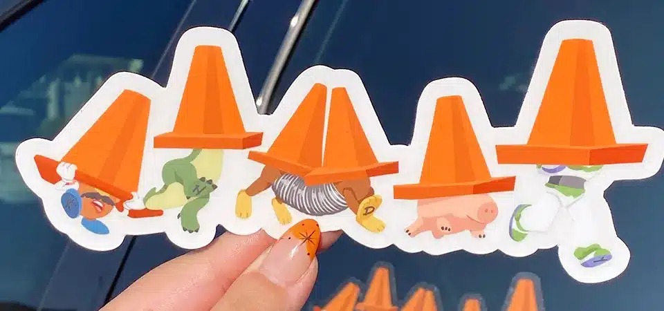 A before and after comparison of a sticker on a car, one new and vibrant, the other faded and cracked