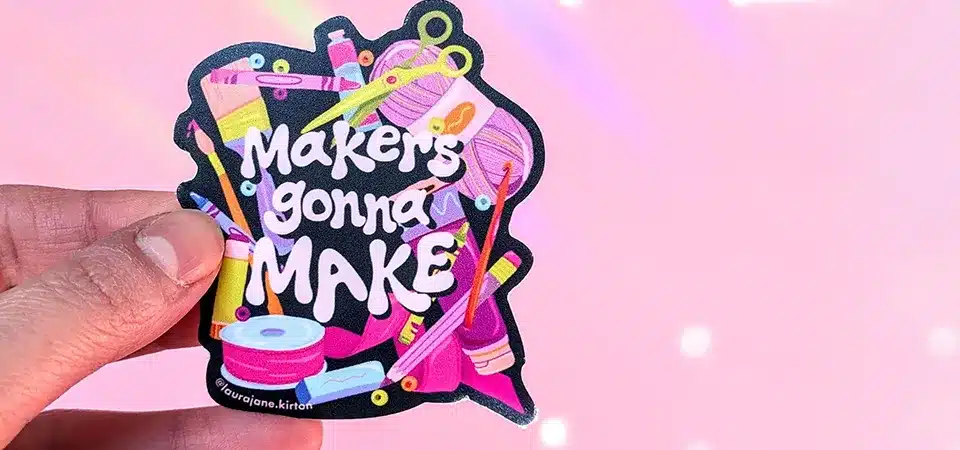 Close up of a pin pricking a small air bubble in a vinyl sticker