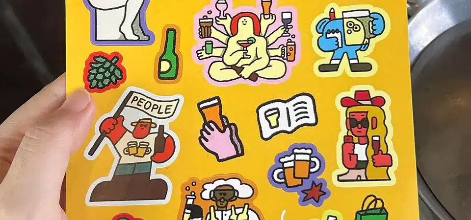 Choosing the Right Sticker Sheet Size A person at a desk looking at different sticker sheet layouts to make a decision