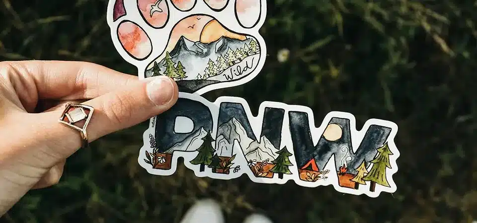 Comparison of paper vs vinyl stickers on a table