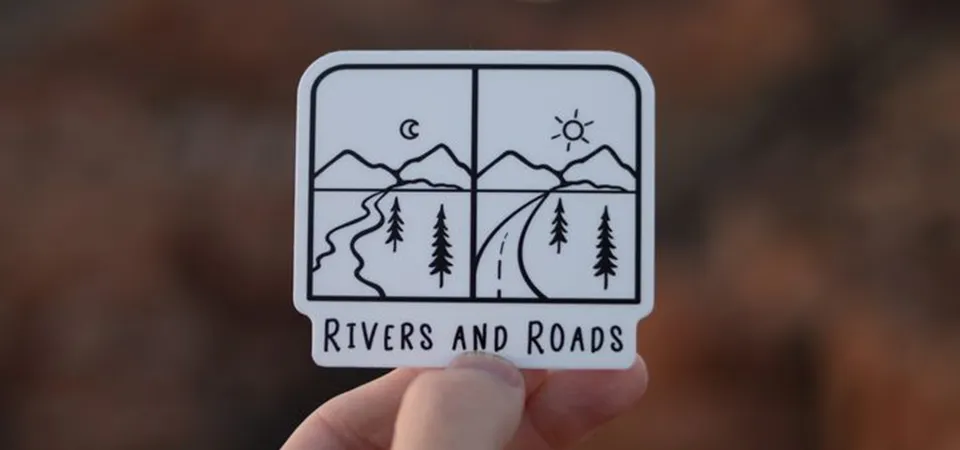 How to Extend Sticker Life A hand using a small squeegee to apply a large vinyl sticker smoothly onto a clean surface