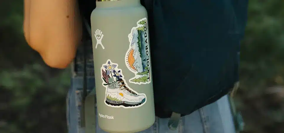 Applying clear sealant to the edge of a sticker