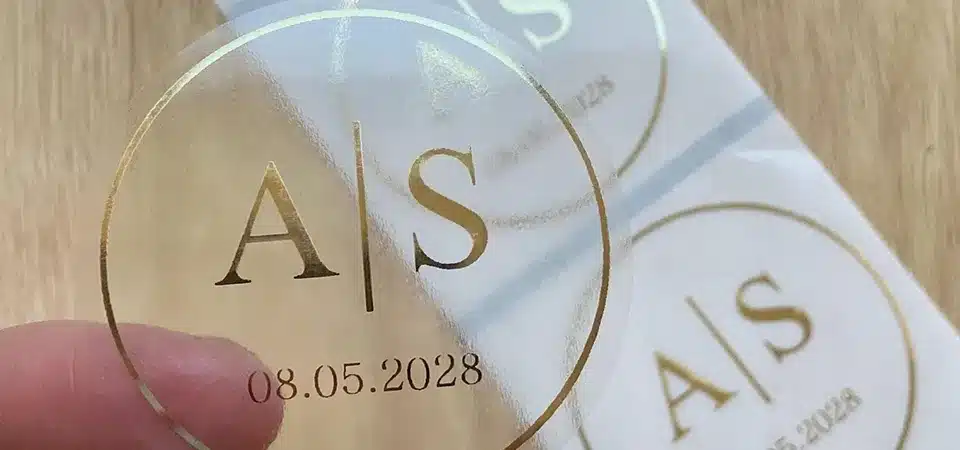 Cutting and applying transparent stickers A digital cutting machine like a Cricut cutting out custom-shaped clear stickers