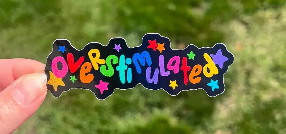 A diagram showing the layers of a waterproof sticker: Vinyl Base, Waterproof Ink, and Protective Laminate