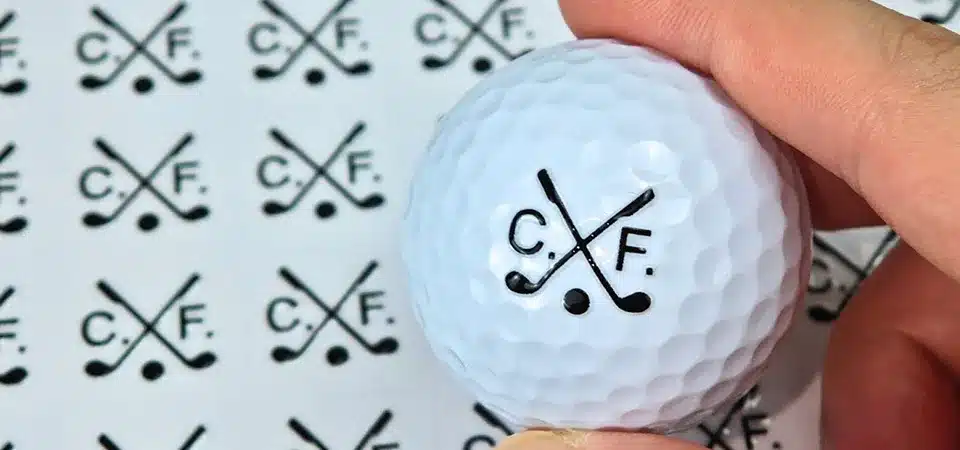 A hand wiping a glass window with a microfiber cloth before applying a sticker