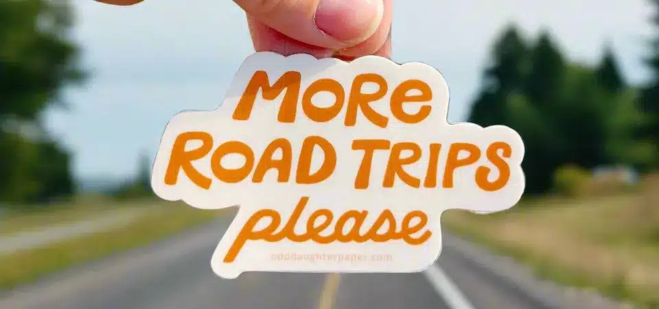 Factors Affecting Sticker Lifespan A close-up diagram showing the layers of a durable sticker: base vinyl, ink, and laminate shield