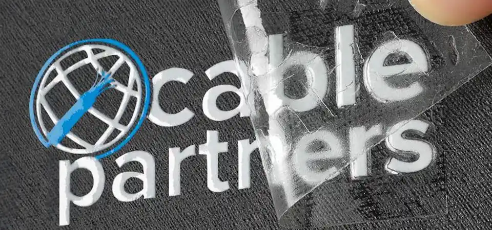 A sticker taped along the top edge, creating a hinge on a car window