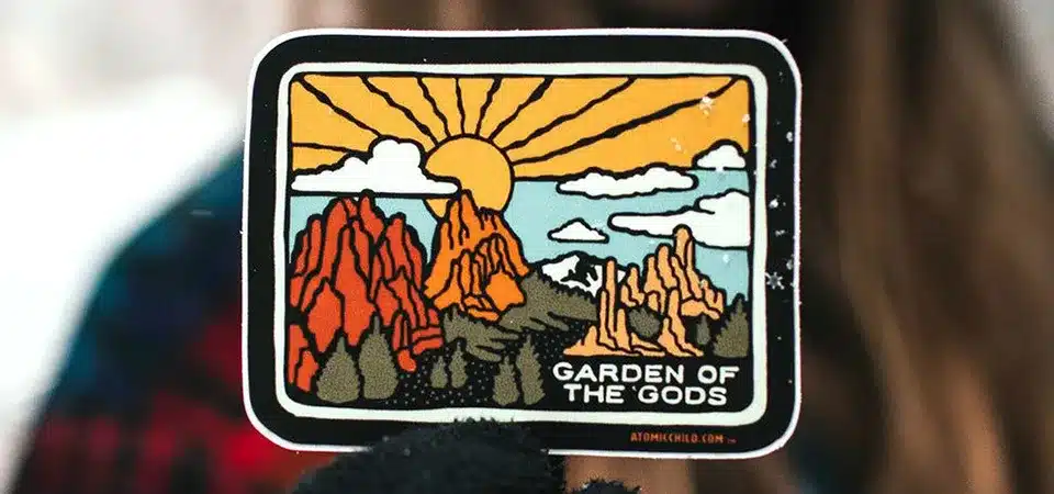 Materials for Long-Lasting Stickers A roll of premium vinyl sticker material next to a finished, laminated outdoor sticker