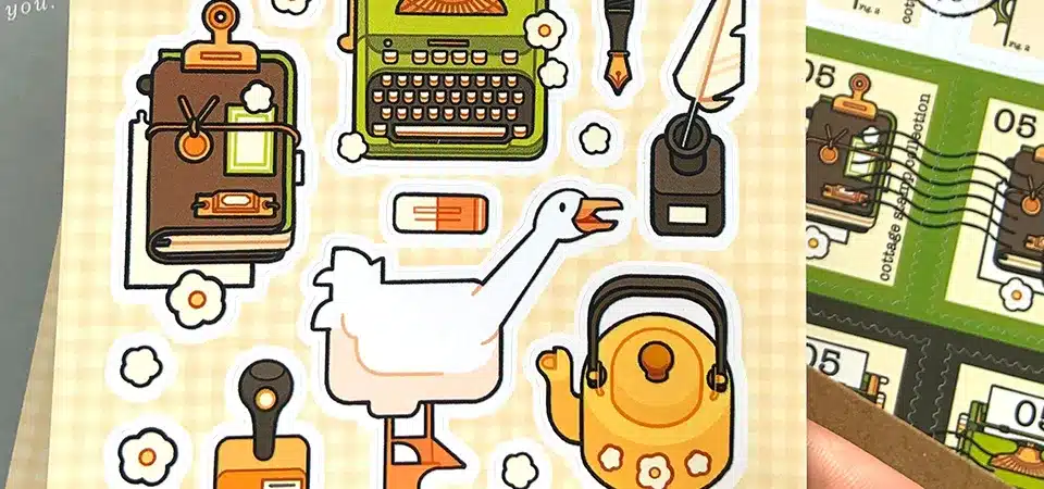 Custom Size vs Standard Size Sticker Sheet A custom-sized sticker sheet next to a standard A4 sheet, highlighting the saved space and efficiency