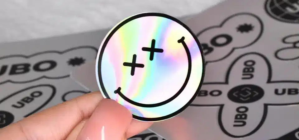 Laptop covered in various die-cut holographic stickers