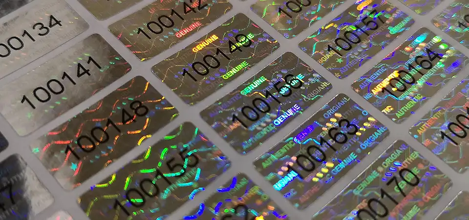 Comparison of a flat printed sticker versus a 3D holographic sticker