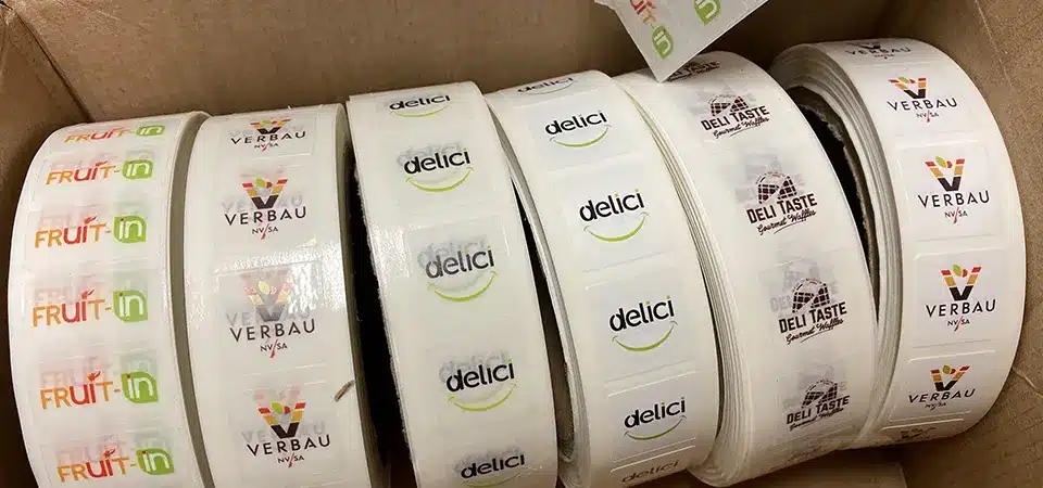 Sticker Roll for Machine Application A large roll of custom product labels loaded onto an industrial labeling machine