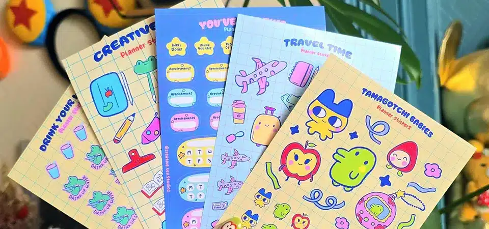 A close-up shot showing the texture and thickness of a premium vinyl sticker sheet with a holographic finish