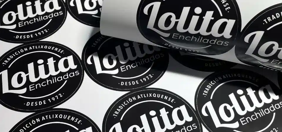 Holding a Tangible Sticker A person holding a custom die-cut sticker in their hand before applying it to a notebook