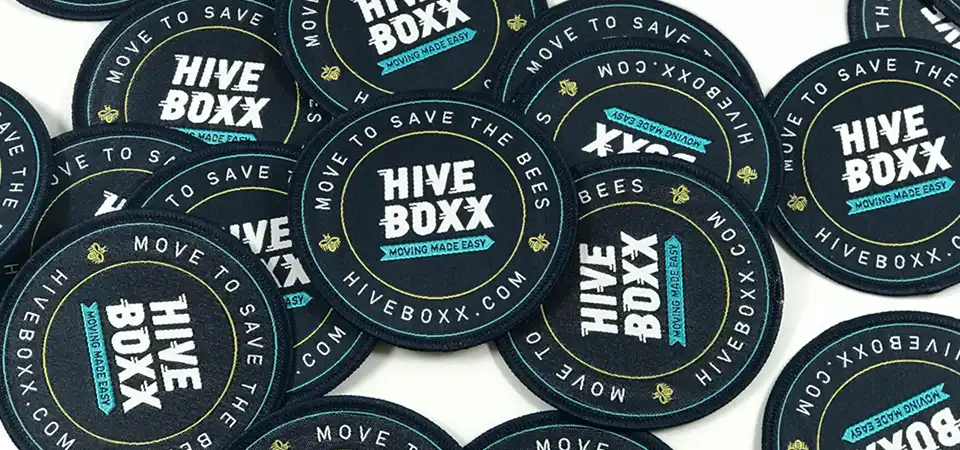 A close-up of a stack of thousands of stickers, all showing the exact same vibrant brand color
