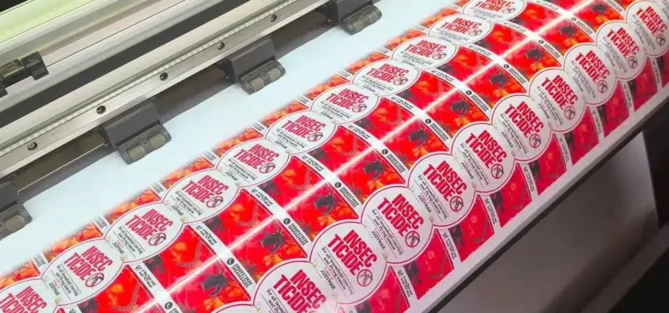 A roll of vibrant, waterproof, die-cut product labels from a professional printing service
