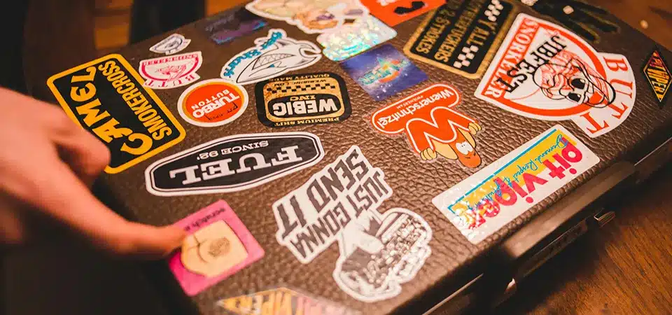 A side-by-side comparison of a glossy vinyl sticker and a matte paper label