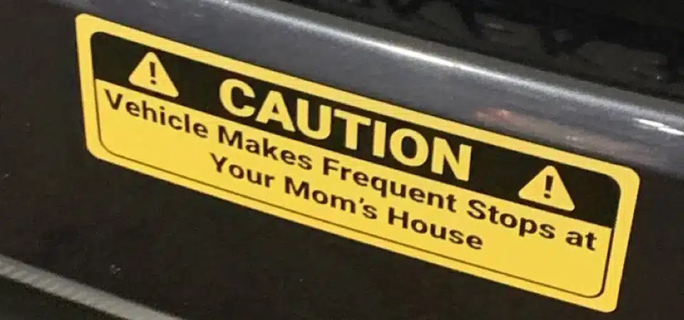 A sticker on a car bumper that still looks vibrant after being exposed to rain and sun